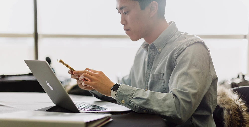 employee managing financial debt during work on his laptop computer
