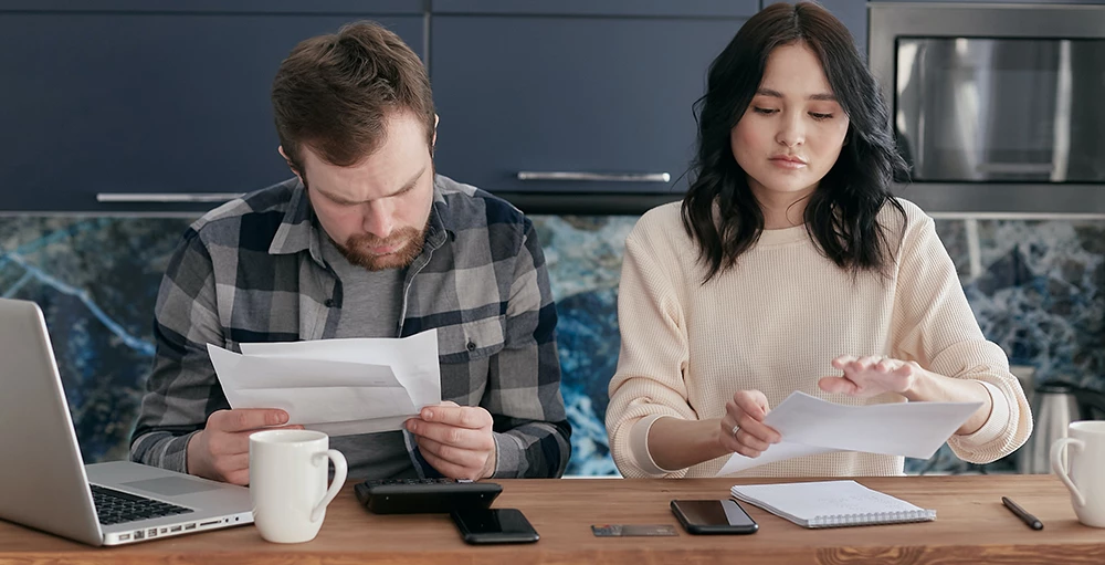 couple reviewing their student loan debt and working on their financial wellness