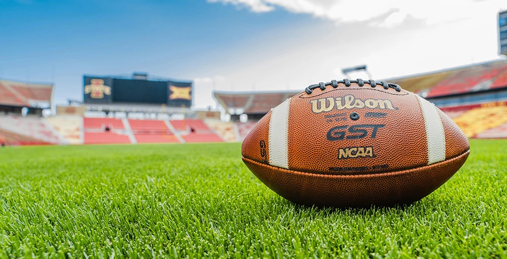 a football sitting on top of a lush green field