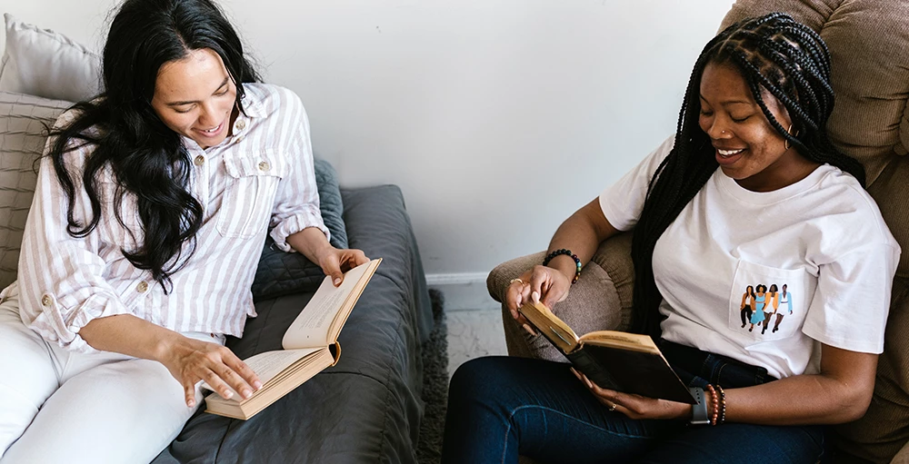 two college students reading books together