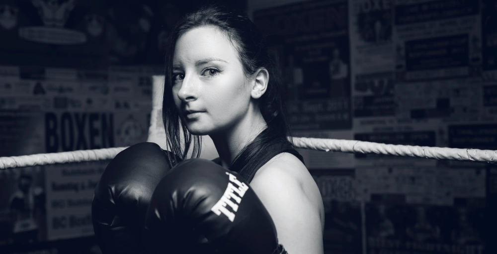 A female boxer showing resilience in the ring during a fight