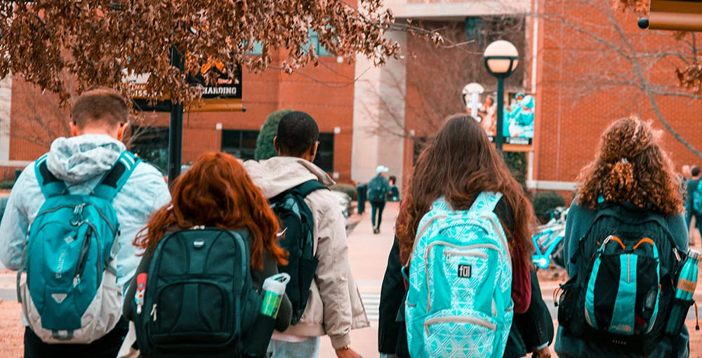 group of college students wearing backpacks