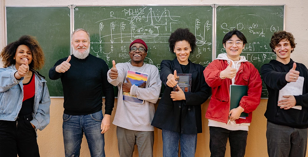 group of college students giving thumbs up