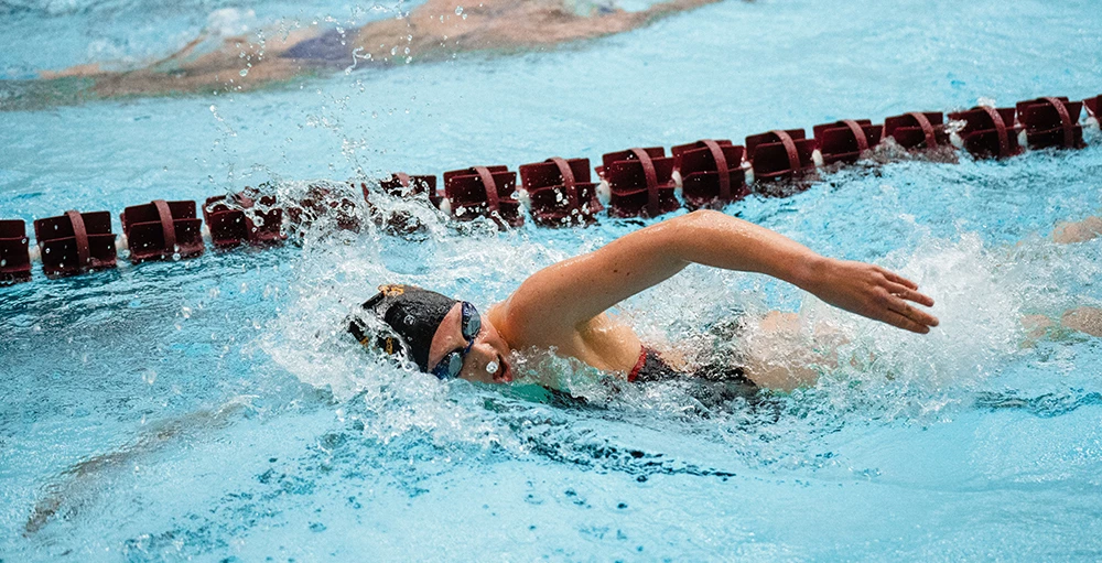 college athlete swimming laps at practice