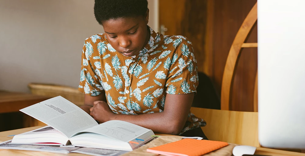 college student reading financial literacy book