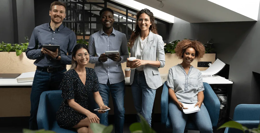 A group of employees smiling in an office