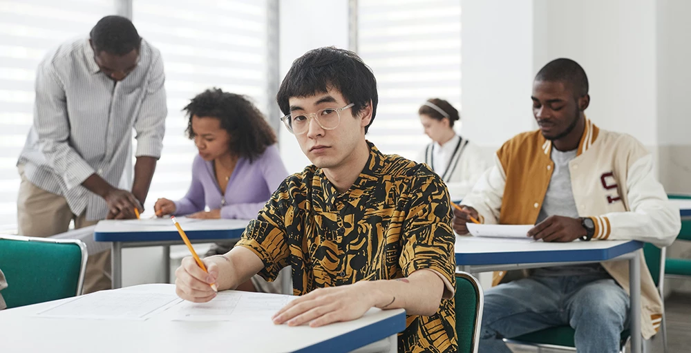 college students taking notes in classroom