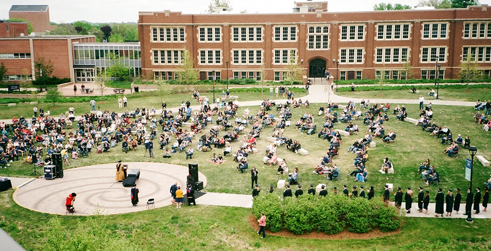 people gathered on lawn at college campus