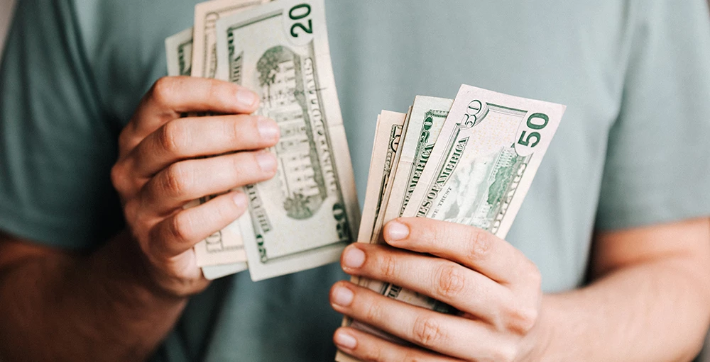close up view of hands holding money
